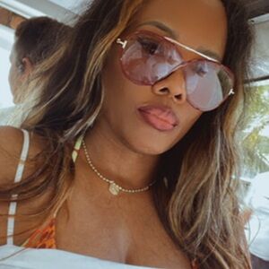 Tom Ford large burgundy sunglasses with soft colored lenses and gold hardware.